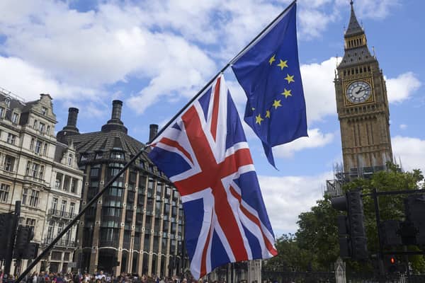 An EU and a Union Flag are seen in front of Elizabeth Tower (Big Ben) during a pro-EU rally in 2017. PIC: NIKLAS HALLE'N/AFP via Getty Images