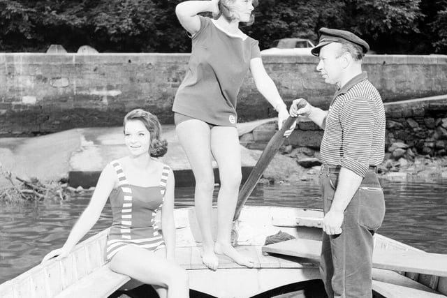 Two models in bathing suits pose with Val Padura, the Cramond ferry man, in 1962.