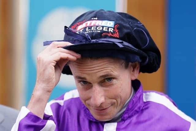 Hat-trick: Jockey Ryan Moore wearing his special St Leger hat after a third win in Britain's oldest Classic at Doncaster.