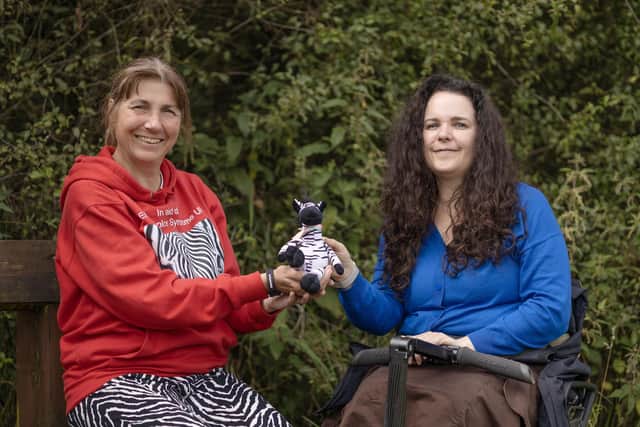 Fran Heley and Cherylee Houston with a zebra, the symbol of the Ehlers-Danlos Support UK charity. Photo: Matt Roberts