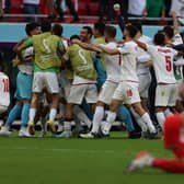 Iran's players celebrate their victory during the Qatar 2022 World Cup Group B football match between Wales and Iran at the Ahmad Bin Ali Stadium in Al-Rayyan (Picture: ADRIAN DENNIS/AFP via Getty Images)