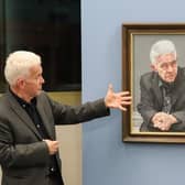 Ian McMillan with a portrait of himself, which is on show at the Library @ the Lightbox in Barnsley until the end of January 2024.