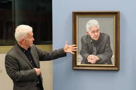 Ian McMillan with a portrait of himself, which is on show at the Library @ the Lightbox in Barnsley until the end of January 2024.