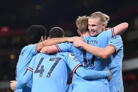 TOPSHOT - Manchester City's Norwegian striker Erling Haaland (R) celebrates with teammates after scoring his team third goal during the English Premier League football match between Arsenal and Manchester City at the Emirates Stadium in London on February 15, 2023. (Photo by GLYN KIRK/AFP via Getty Images)