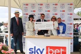 First past the post The Sporting Memories Foundation celebrate £20,000 win - left to right, Trawlerman trainer John Gosden, Chairman of York Racecourse Bridget Guerin,  CEO Flutter UK & Ireland Conor Grant , Partnerships Director of The Sporting Memories Foundation Susie Brindley and jockey Frankie Dettori.