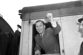 Len Hutton waving from the window of a train at St Pancras Station, London, as the England team leave for their tour of Australia in 1954-55. Photo by Jimmy Sime/Central Press/Getty Images.