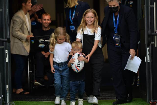 Rob Burrow's children Macy, Maya and Jackson bring out the match ball as Rob watches on before Leeds Rhinos v Huddersfield Giants in August 2021. Picture: Jonathan Gawthorpe