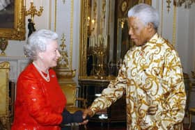 Britain's Queen Elizabeth II (L) meets with former South African President Nelson Mandela (R) during a reception at Buckingham Palace in London on October 20, 2003. Former Yorkshire MP Richard Caborn has said he was a "little bit economical with the truth" in telling Mr Mandela that the Queen wanted him to support the London Olympic bid. Photo by KIRSTY WIGGLESWORTH / POOL / AFP)