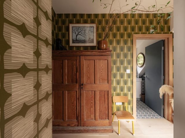 The well-planned dressing room provides ample storage, complementing the bedroom’s clean lines and considered design.