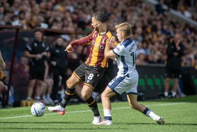 Bradford City's Adam Phillips fends off Mansfield Town's Liam Thompson. Photo: Tony Johnson.