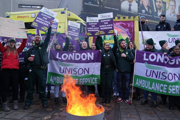 Ambulance workers on the picket line outside Waterloo ambulance station in London, as paramedics, ambulance technicians and call handlers walk out in England and Wales, in a strike co-ordinated by the GMB, Unison and Unite unions over pay and conditions that will affect non-life threatening calls. Picture date: Wednesday December 21, 2022.