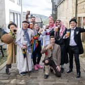 The cast of the Heptonstall Pace Egg having a Good Friday pint in the village between performances in Weavers Square in the West Yorkshire Village.