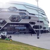 Pictured: A Leeds City Council Worker cutting the grass outside the arena