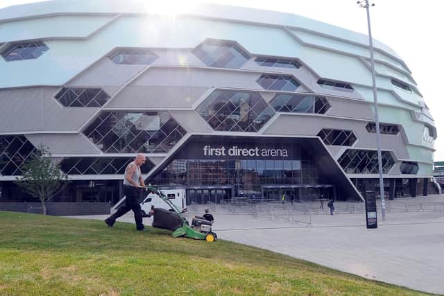 Pictured: A Leeds City Council Worker cutting the grass outside the arena