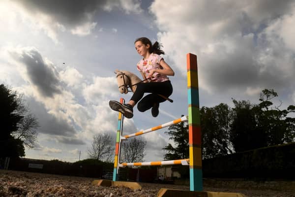 Hobbyhorse Adventures Colton, Leeds.  Annabel Hilton is pictured jumping with her Hobby Horse Picture taken by Yorkshire Post Photographer Simon Hulme