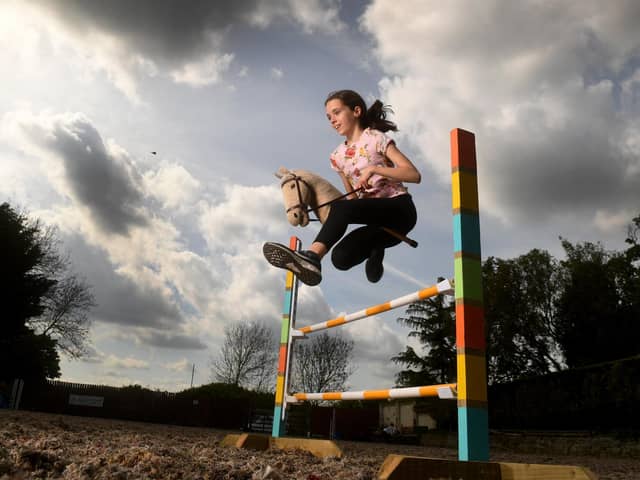 Hobbyhorse Adventures Colton, Leeds.  Annabel Hilton is pictured jumping with her Hobby Horse Picture taken by Yorkshire Post Photographer Simon Hulme
