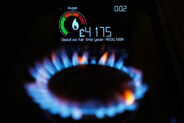 A file photo of a handheld smart meter on a kitchen hob showing the cost of a year-to-date's worth of home energy usage in a home. PIC: Yui Mok/PA Wire