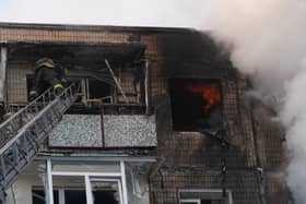 Firefighters put out a fire in an apartment house following a Russian drone attack in Kharkiv, Ukraine. PIC: AP Photo/Andrii Marienko