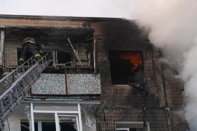 Firefighters put out a fire in an apartment house following a Russian drone attack in Kharkiv, Ukraine. PIC: AP Photo/Andrii Marienko