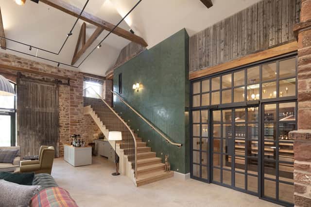 The conversion gives generous reference to the buildings' heritage. Stairs lead to the snug/bar and the glazed door leading to the kitchen/dining area