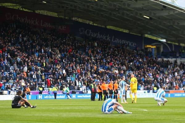Crestfallen Huddersfield Town players react to the 1-1 draw after the final whistle of the Sky Bet Championship match with Birmingham City at the John Smith's Stadium, a result which has effectively relegated the Terriers. Photo by Ashley Allen/Getty Images.