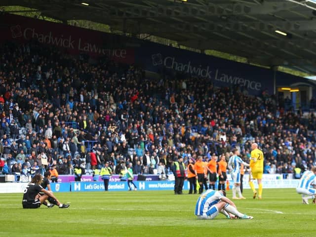 Crestfallen Huddersfield Town players react to the 1-1 draw after the final whistle of the Sky Bet Championship match with Birmingham City at the John Smith's Stadium, a result which has effectively relegated the Terriers. Photo by Ashley Allen/Getty Images.