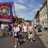 Colliery banners are carried through the city in Durham
