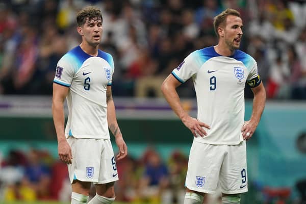 England's John Stones (left) and Harry Kane appear dejected during the FIFA World Cup Group B match at the Al Bayt Stadium in Al Khor, Qatar. Picture: Mike Egerton/PA Wire.