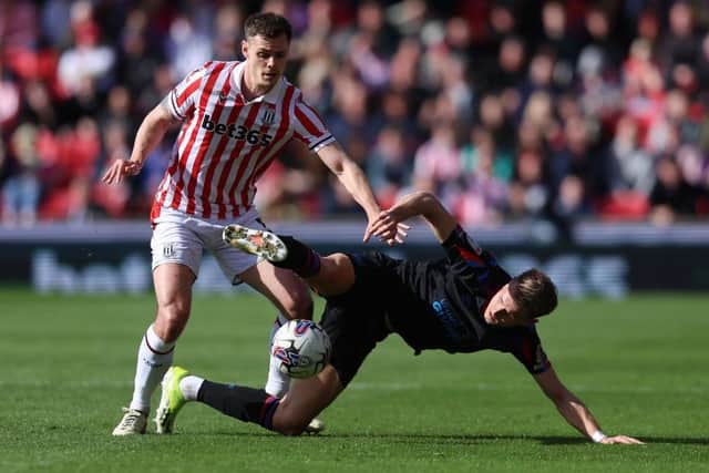 STOKE ON TRENT, ENGLAND - APRIL 01: Bojan Radulovic of Huddersfield Town is challenged by Michael Rose of Stoke City during the Sky Bet Championship match between Stoke City and Huddersfield Town at Bet365 Stadium on April 01, 2024 in Stoke on Trent, England. (Photo by Nathan Stirk/Getty Images) (Photo by Nathan Stirk/Getty Images)
