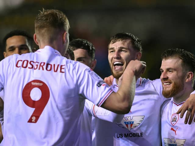 Barnsley striker John McAtee (centre) celebrates his side's second goal with Sam Cosgrove during the Sky Bet League One match at Carlisle United earlier this month. Photo by Stu Forster/Getty Images.