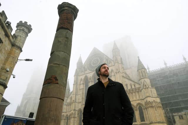 Adam Parker, who has written a book called Treasures of Roman Yorkshire. Pictured next to the Roman column which stands in York Minster Yard.