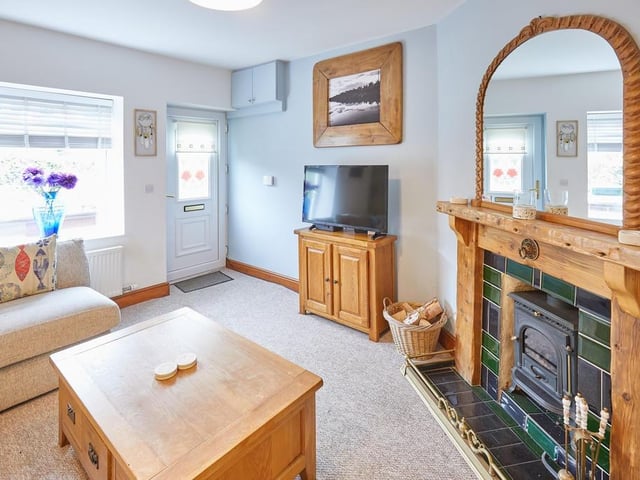 The sitting room has a cosy, multi-fuel stove and is beautifully decorated