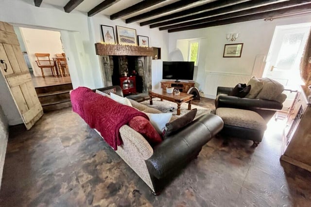 One of the large reception rooms in the cottage complete with cosy stove