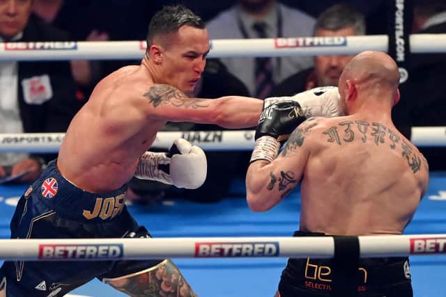 Josh Warrington (L) punches Kiko Martinez during the IBF World Featherweight Title fight (Picture: Stu Forster/Getty Images)