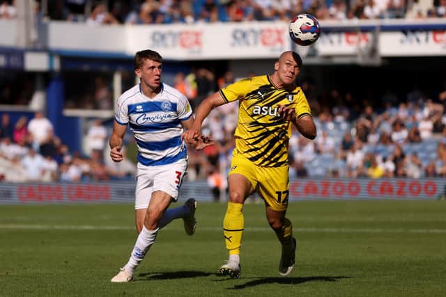 LONDON, ENGLAND - AUGUST 20: Georgie Kelly of Rotherham United and Jimmy Dunne of Queens Park Rangers battle for the ball during the Sky Bet Championship match between Queens Park Rangers and Rotherham United at Loftus Road on August 20, 2022 in London, England. (Photo by Paul Harding/Getty Images)