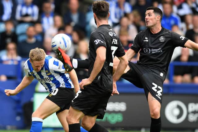 WHERE IT HURTS: Davis Kellor-Dunn ducks into a header (Image: Steve Ellis)