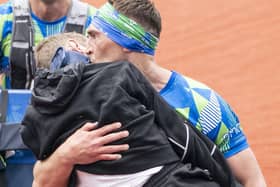 Kevin Sinfield kisses Rob Burrow as he carries him across the finish line of the 2023 Rob Burrow Leeds Marathon. (Photo: Danny Lawson)