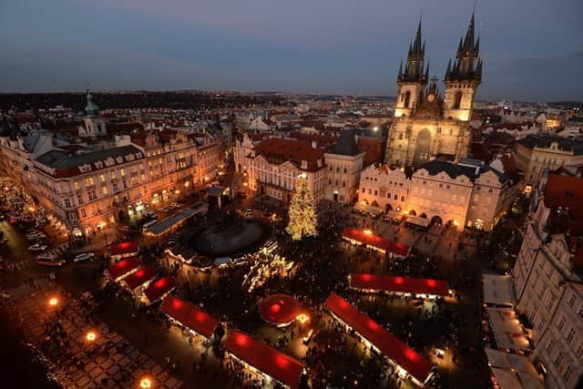 An illuminated Christmas tree is seen at the market at the Old Town Square in Prague. (Pic credit: Michal Cizek / AFP via Getty Images)