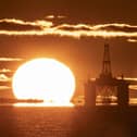 The sun rising behind a redundant oil platform. PIC: Jane Barlow/PA Wire