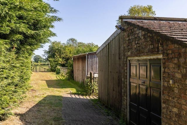 Outbuildings include a garage and a home office