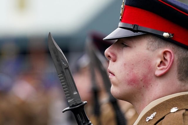 A close up shot of a junior soldier holding up a sword.
