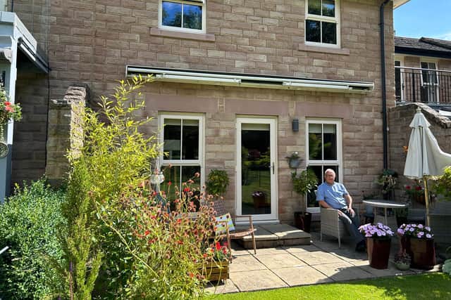 John Robson enjoying the south-facing garden in his compact and stylish bijoux home