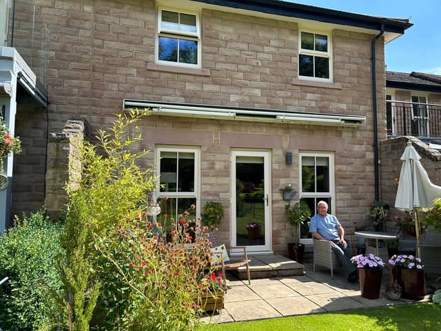 John Robson enjoying the south-facing garden in his compact and stylish bijoux home