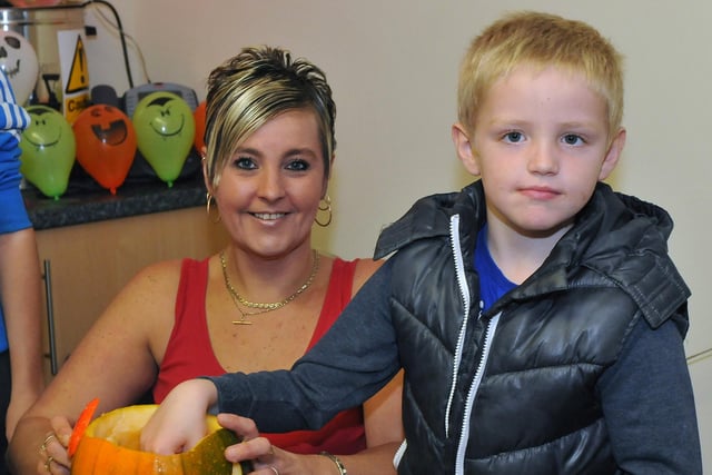 Nichola Ditchburn with her son Kyle Brown scoop out the inside of their pumpkin in a creative 2012 Halloween session. Who can tell us more?