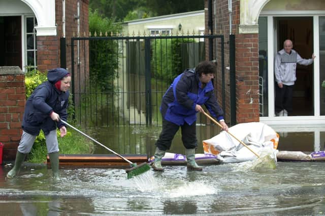 Householders clean-up after floods in Hull in 2007. PIC: Terry Carrott