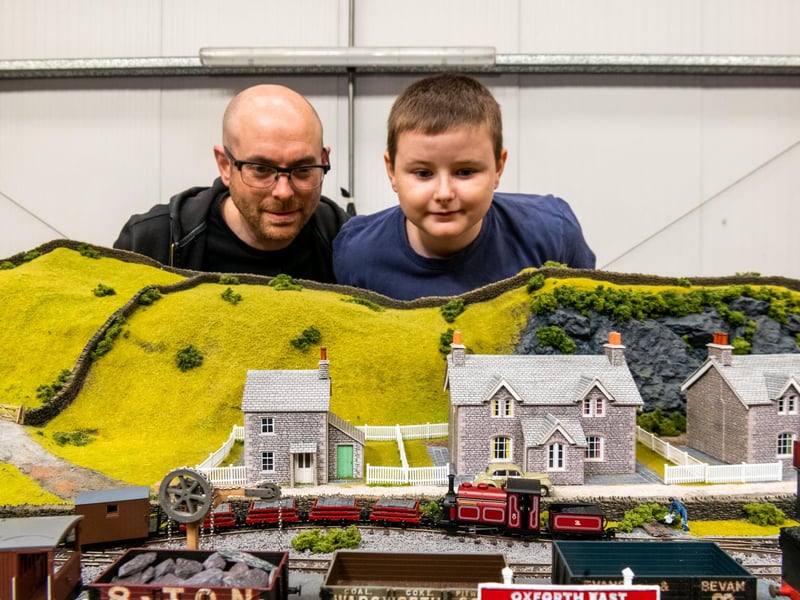 Peter Morley, of Leeds, with his son Tommy, aged 8, and their 00 & 009 gauge layout titled 'Oxford East' fictional scene in North Wales.