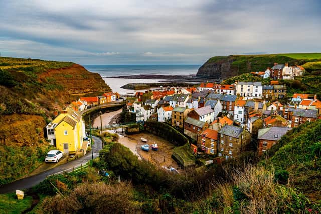 Staithes in North Yorkshire, an old fishing village bursting with charm huddled cottages, winding streets and towering cliffs. 
Picture By Yorkshire Post Photographer,  James Hardisty.