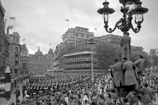 Crowds in Trafalgar Square in the rain watch as Troops march past on the return from Westminster Abbey after the Queen's crowning at her Coronation. PIC: PA Wire