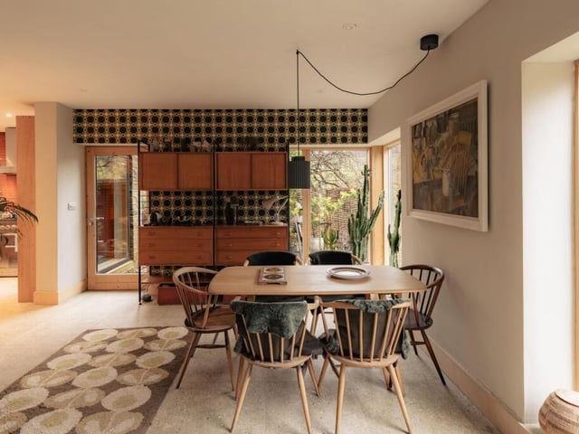 The entire ground floor is finished with porcelain tiles from Mandarin Stone, while wallpaper by Orla Kiely adorns two walls.