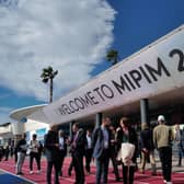 People walk past the MIPIM international real estate event for professionals at the Palais des Festivals in Cannes, southeastern France, on March 14, 2023. (Photo by Valery HACHE / AFP) (Photo by VALERY HACHE/AFP via Getty Images)